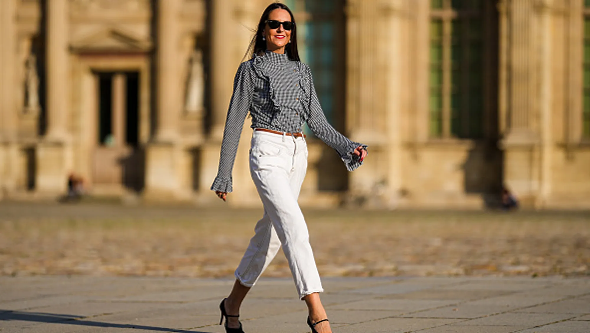 woman in black blouse and white pants