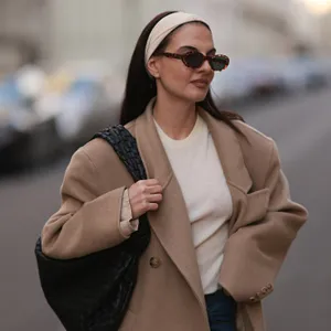 woman wearing headband and beige blazer