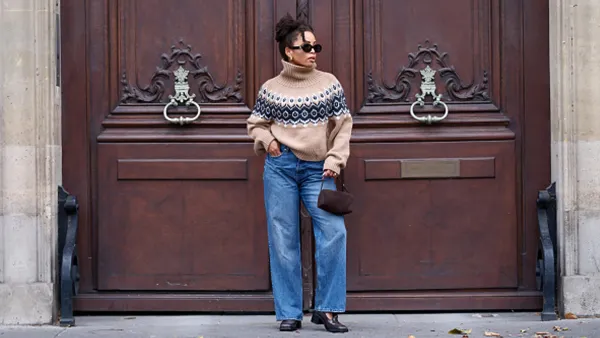 woman wearing fall sweater and jeans