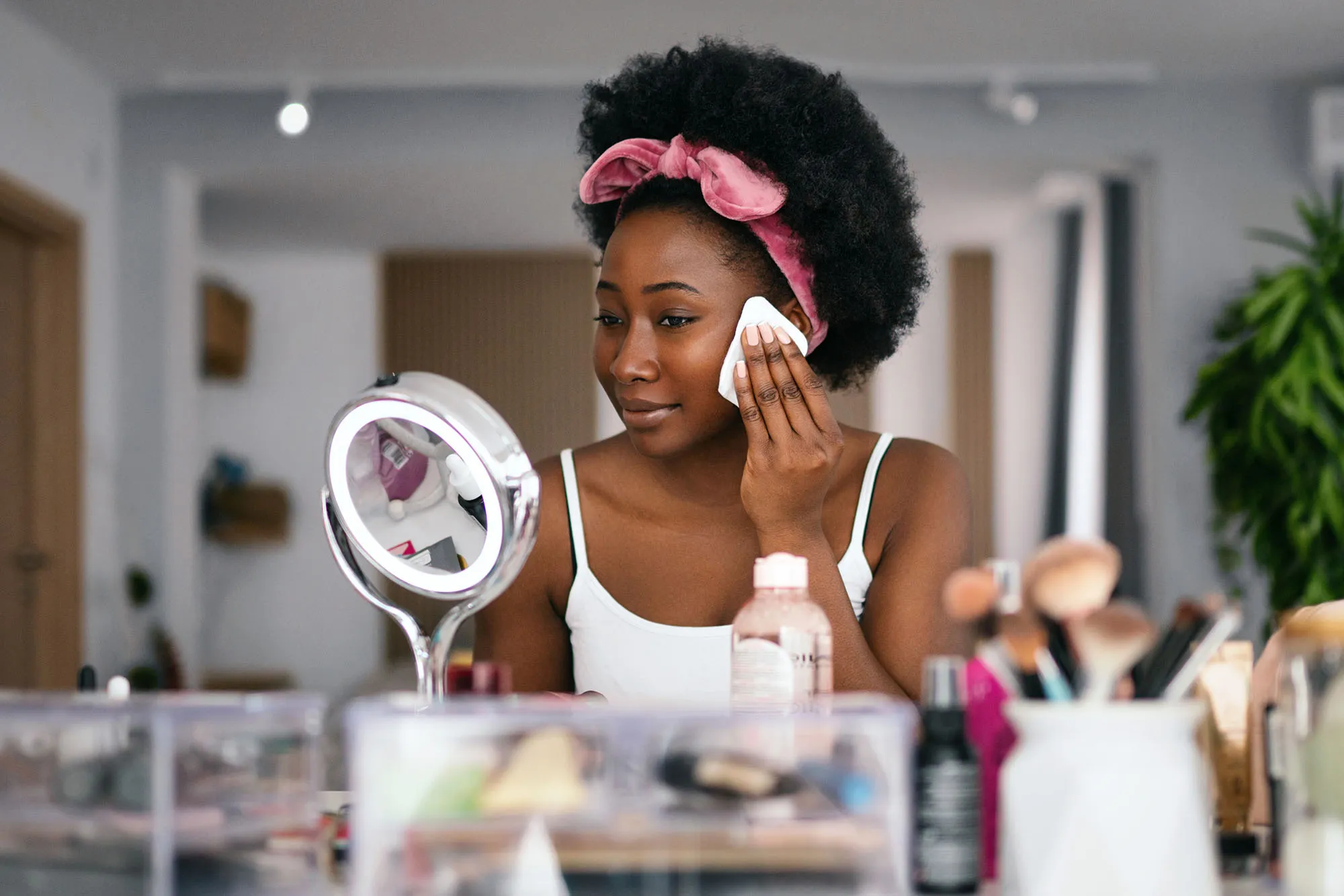Beautiful woman cleaning her face with a face cloth.