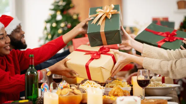 The family is happily exchanging gifts at Christmas.
