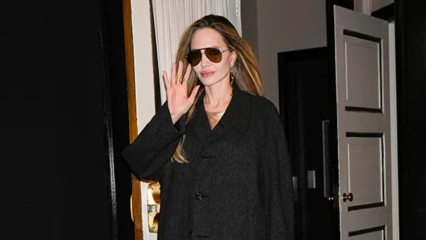 angelina jolie in black trench coat