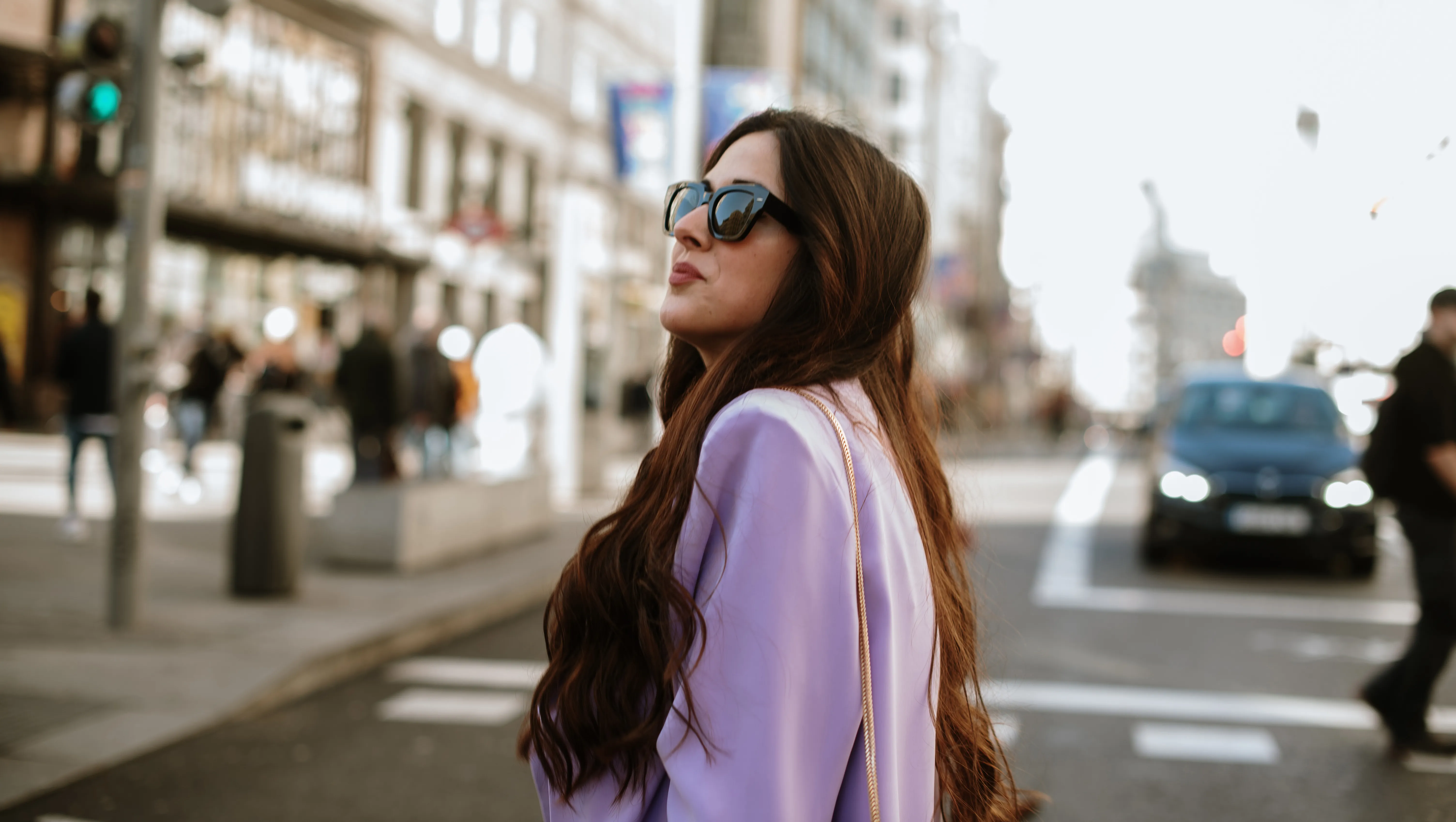 Portrait of a young woman with sunglasses in a city