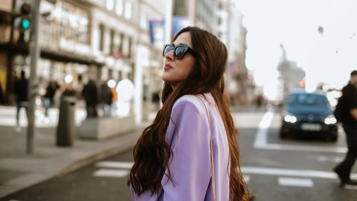 Portrait of a young woman with sunglasses in a city