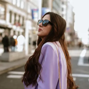 Portrait of a young woman with sunglasses in a city