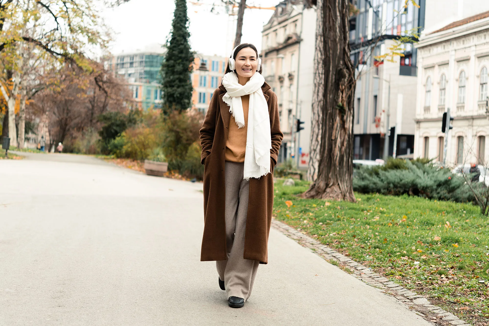 Portrait of a happy Asian woman enjoying music on the move