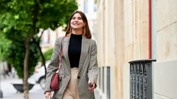 women wearing blazer walking on street