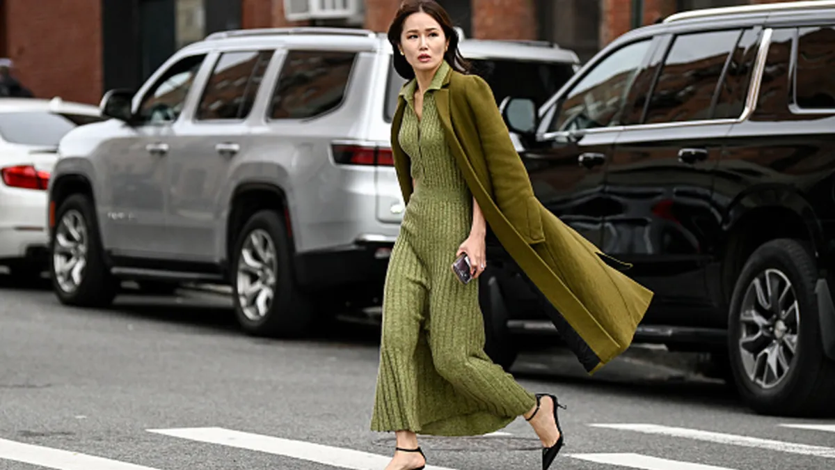 woman wearing green knitted sweater dress and trench coat