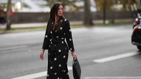 woman wearing black and white polka dotted dress