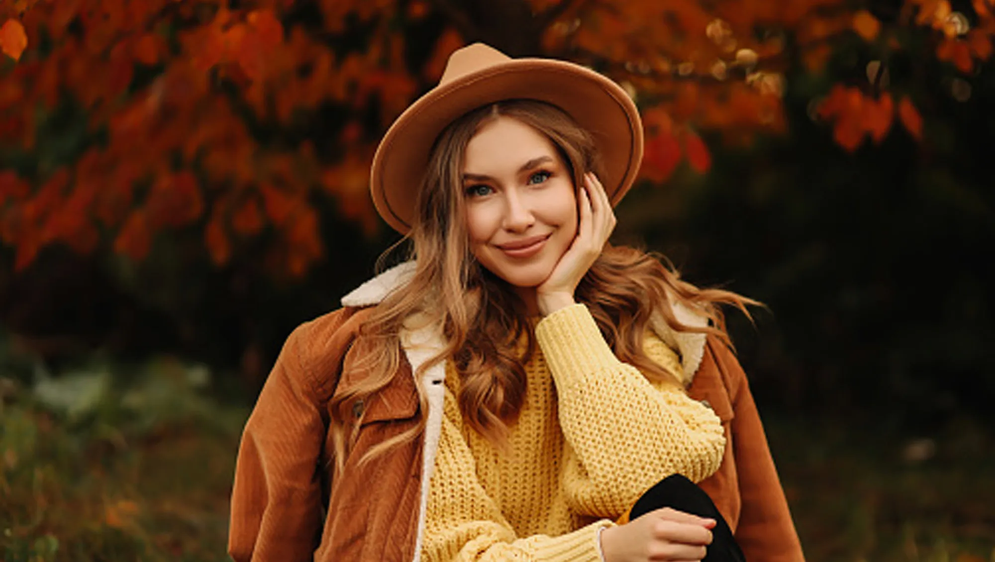 woman wearing yellow sweater, hat and coat