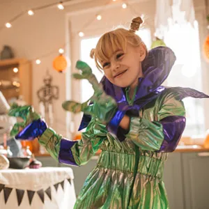 kid in halloween costume with mom