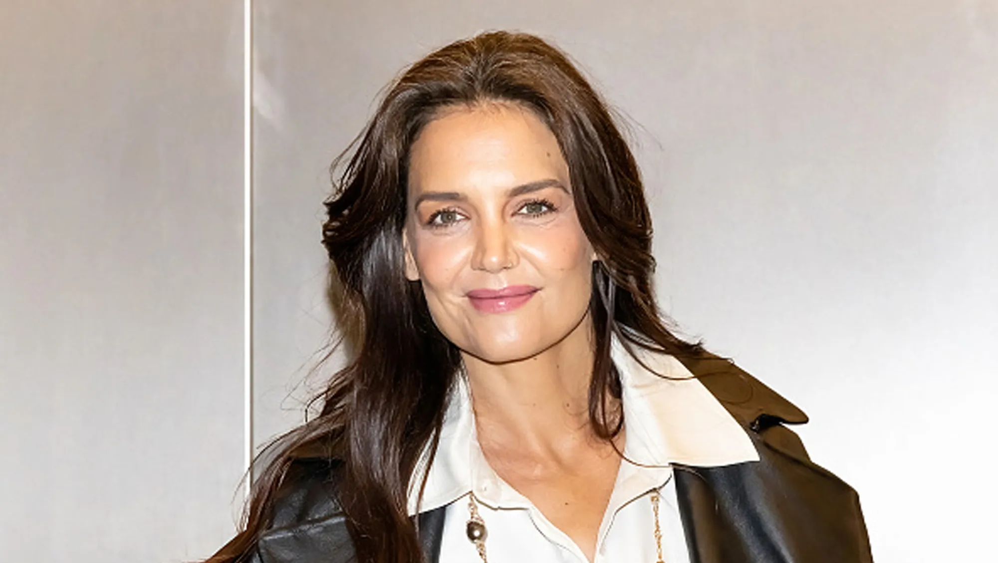katie holmes in white button up and black coat