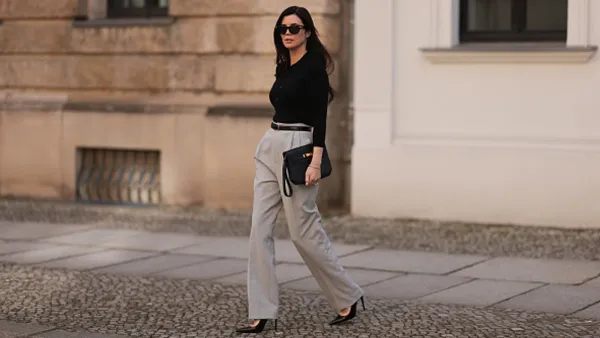 woman wearing black top and beige trousers