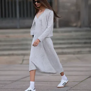 woman wearing gray sweater dress and sneakers