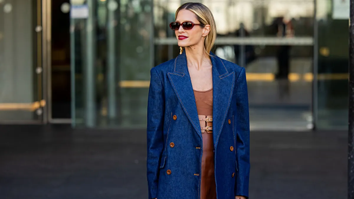woman wearing blue blazer and brown dress