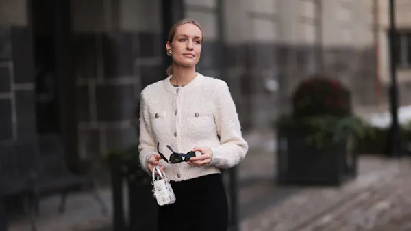 woman wearing white cardigan and black pants