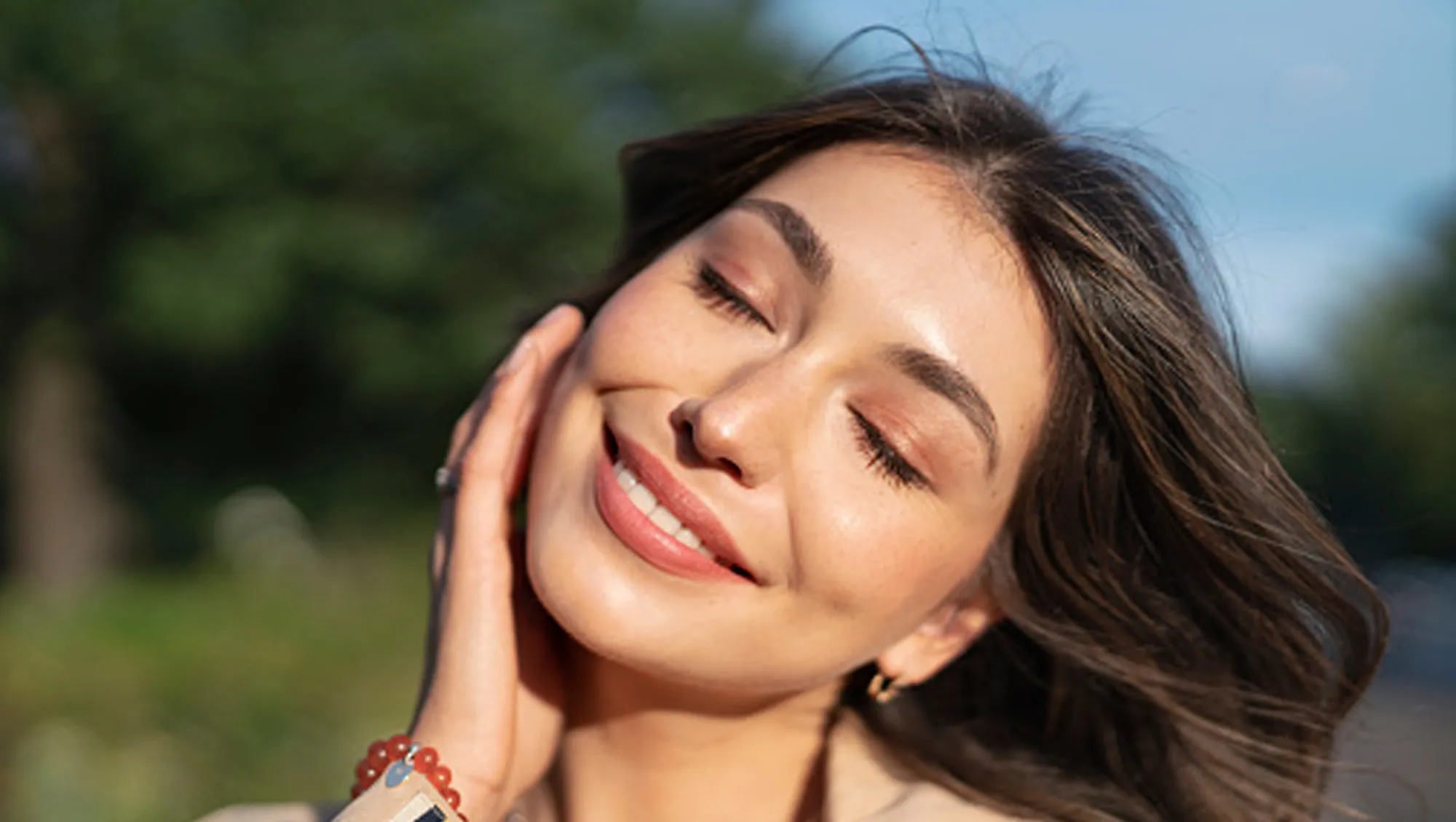 woman holding face with clean makeup