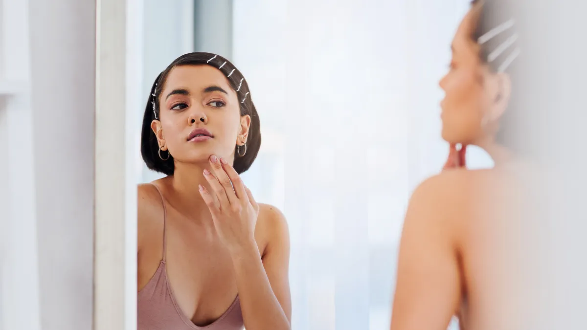 Shot of an attractive young woman going through her morning beauty routine at home