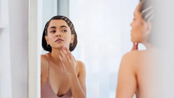Shot of an attractive young woman going through her morning beauty routine at home