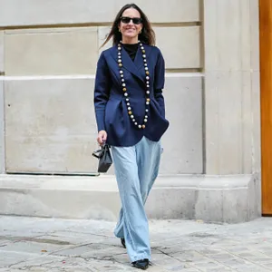 woman wearing blue top and slacks