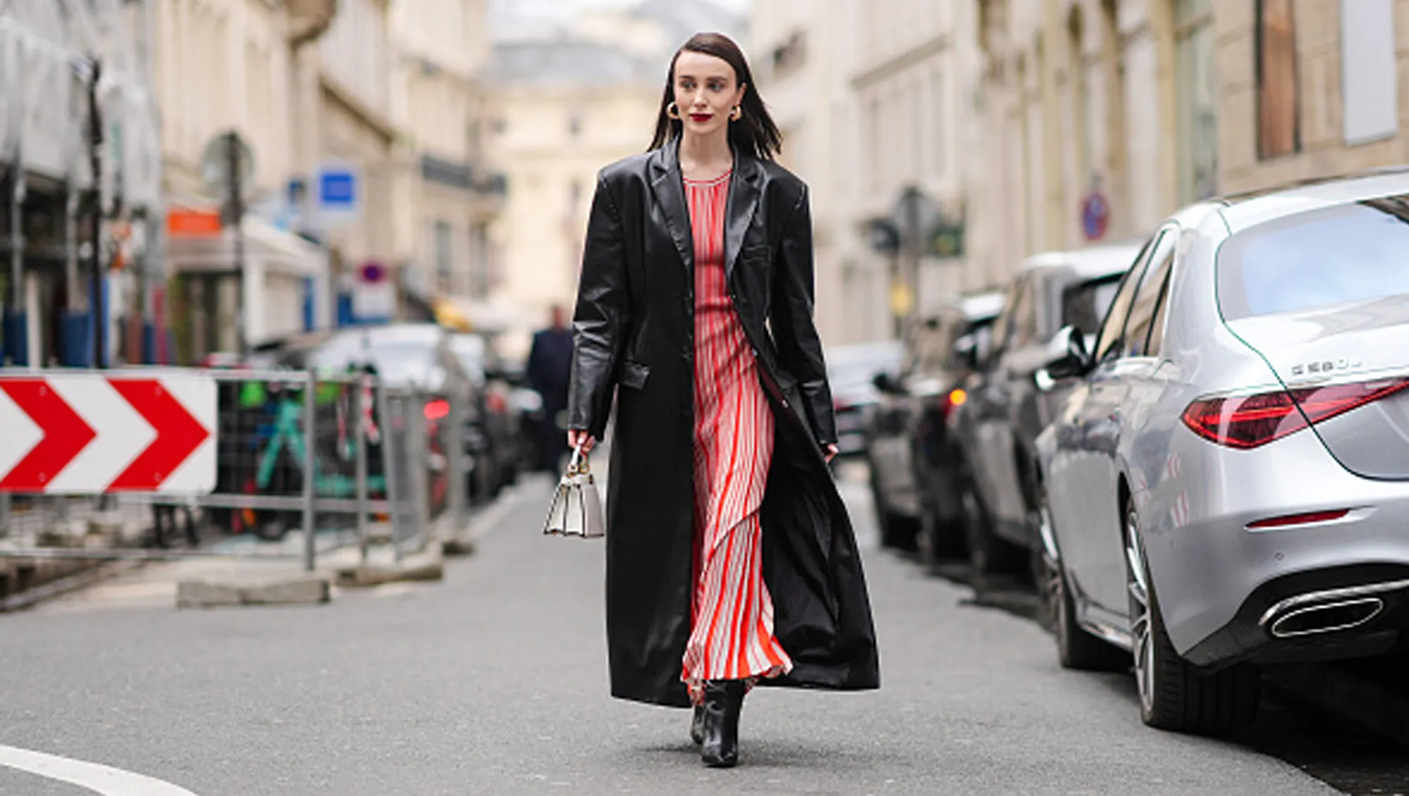 woman wearing red dress and black coat