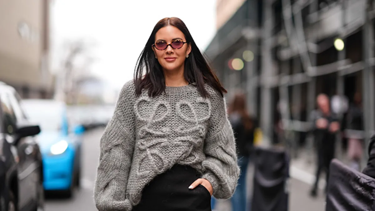 woman wearing gray sweater in streets