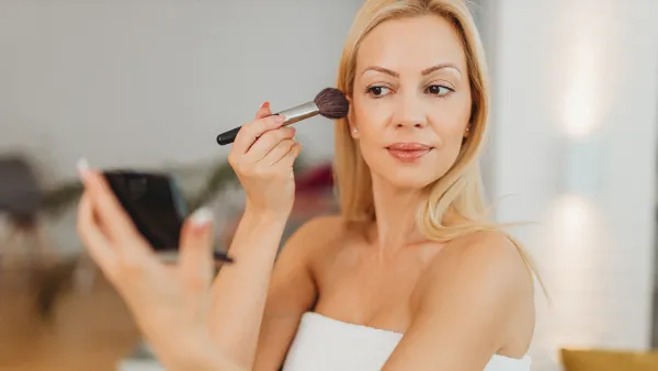 Woman applying powder at home