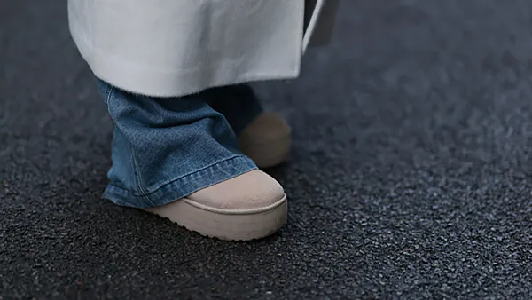 BERLIN, GERMANY - JANUARY 14: Anna Winter seen wearing Source Unknown cream white wool oversized long coat, Source Unknown blue oversized wide leg denim jeans / pants and UGG Plattform beige suede leather boots, on January 14, 2024 in Berlin, Germany. (Photo by Jeremy Moeller/Getty Images)