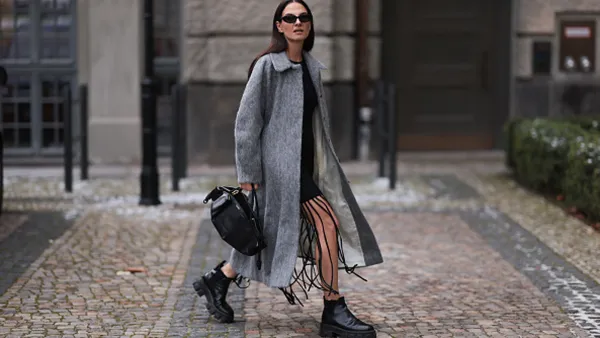 woman wearing gray coat and black boots