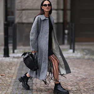 woman wearing gray coat and black boots