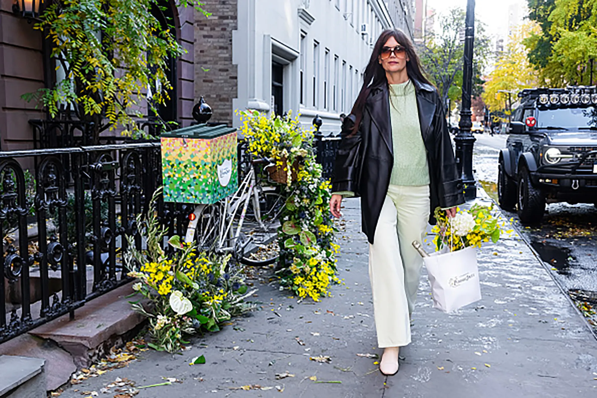 NEW YORK, NEW YORK - NOVEMBER 27: Katie Holmes is seen in NYC receiving a delivery of flowers and champagne from Perrier-Jouët on a chic, nature-inspired bicycle adorned with local blooms on November 27, 2023 in New York City. (Photo by Gotham/GC Images)
