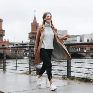 Young woman walking by river in Berlin, Germany