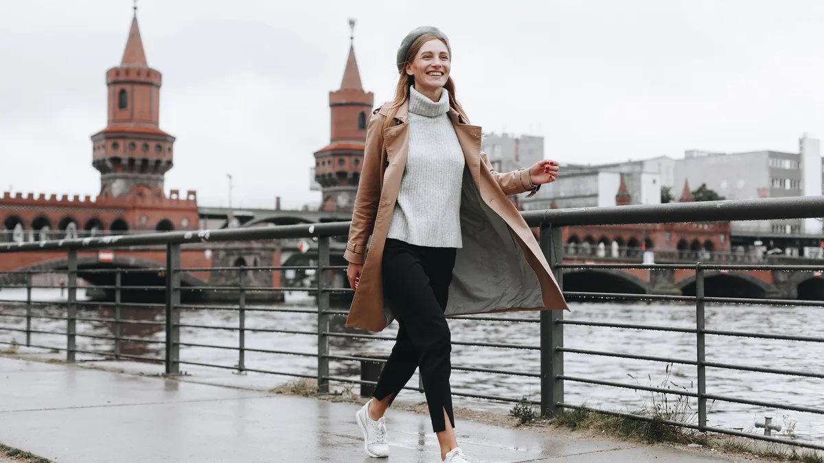 Young woman walking by river in Berlin, Germany