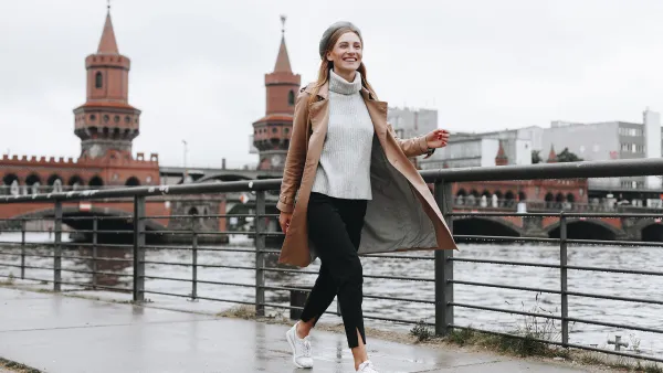 Young woman walking by river in Berlin, Germany