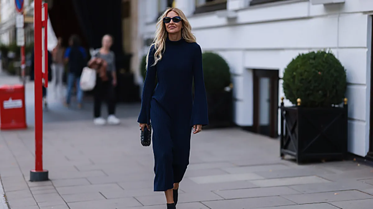 HAMBURG, GERMANY - SEPTEMBER 02: Sue Giers is seen wearing a black Miu Miu bag, black Celine sunglasses, Jimmy choo black heels, SoSue blue dress, 360cashmere Poncho on September 02, 2022 in Hamburg, Germany. (Photo by Jeremy Moeller/Getty Images)