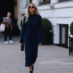 HAMBURG, GERMANY - SEPTEMBER 02: Sue Giers is seen wearing a black Miu Miu bag, black Celine sunglasses, Jimmy choo black heels, SoSue blue dress, 360cashmere Poncho on September 02, 2022 in Hamburg, Germany. (Photo by Jeremy Moeller/Getty Images)
