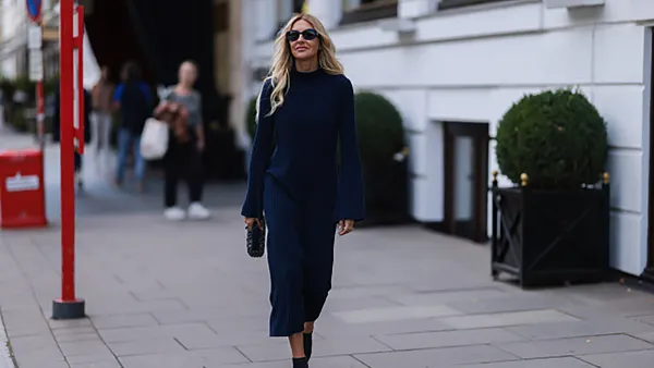HAMBURG, GERMANY - SEPTEMBER 02: Sue Giers is seen wearing a black Miu Miu bag, black Celine sunglasses, Jimmy choo black heels, SoSue blue dress, 360cashmere Poncho on September 02, 2022 in Hamburg, Germany. (Photo by Jeremy Moeller/Getty Images)