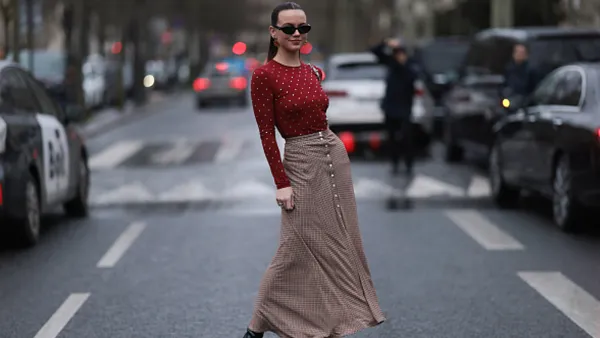 woman wearing red top and beige maxi skirt
