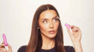 Lauryn Bosstick holding her peptide product 172