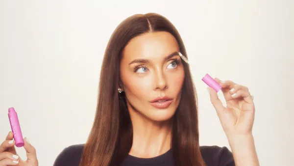 Lauryn Bosstick holding her peptide product 172