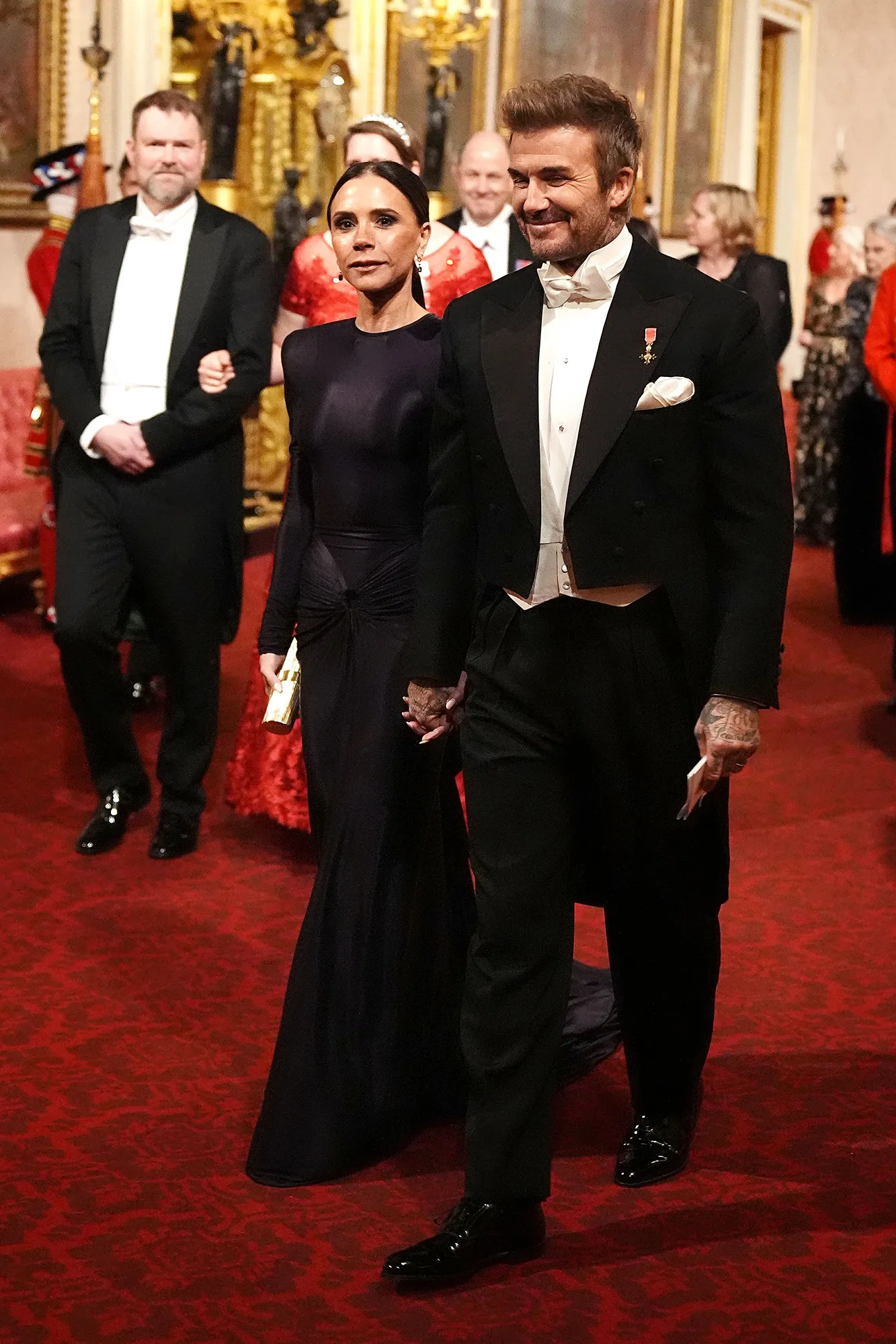 Victoria and David Beckham Hold Hands During Event at Buckingham Palace