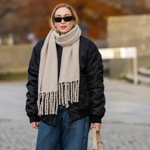 BERLIN, GERMANY - NOVEMBER 26: Sonia Lyson wears jeans and jacket Closed, FTC scarf, bag Nanushka, sunglasses Prada on November 26, 2024 in Berlin, Germany. (Photo by Christian Vierig/Getty Images)