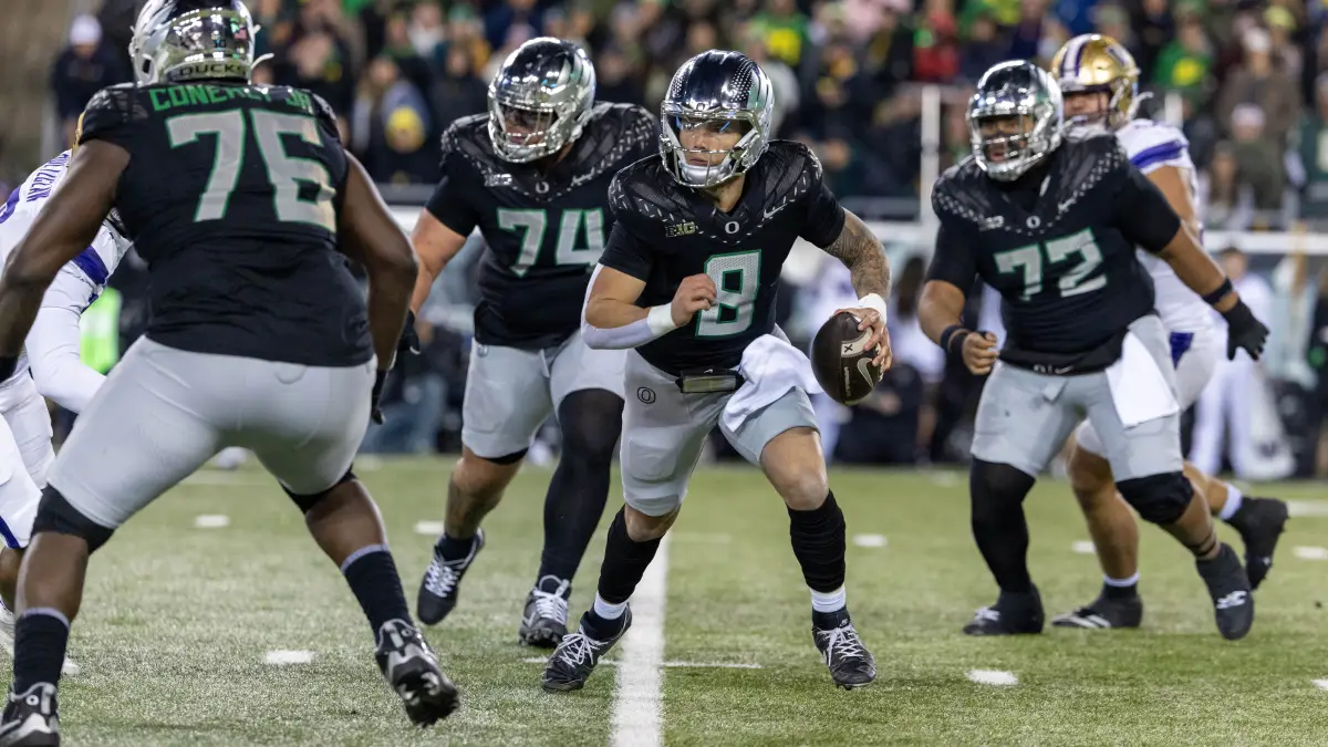 EUGENE, OREGON - NOVEMBER 30: Quarterback Dillon Gabriel #8 of the Oregon Ducks runs to pass the ball in the first half against the Washington Huskies at Autzen Stadium on November 30, 2024 in Eugene, Oregon. (Photo by Tom Hauck/Getty Images)