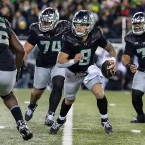 EUGENE, OREGON - NOVEMBER 30: Quarterback Dillon Gabriel #8 of the Oregon Ducks runs to pass the ball in the first half against the Washington Huskies at Autzen Stadium on November 30, 2024 in Eugene, Oregon. (Photo by Tom Hauck/Getty Images)