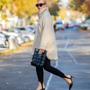 Tina Haase wearing Object fleece zip sweater, Zara stirrup leggings, Skergeth bag, Chanel sunglasses, Zara heels on November 01, 2021 in Berlin, Germany.
