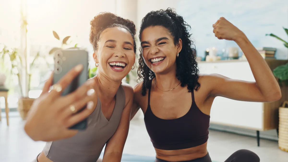 House, selfie and women with fitness, flexing and training with smile, confidence and pride. Smartphone, apartment and friends with happiness, wellness and excited with challenge, healthy and workout