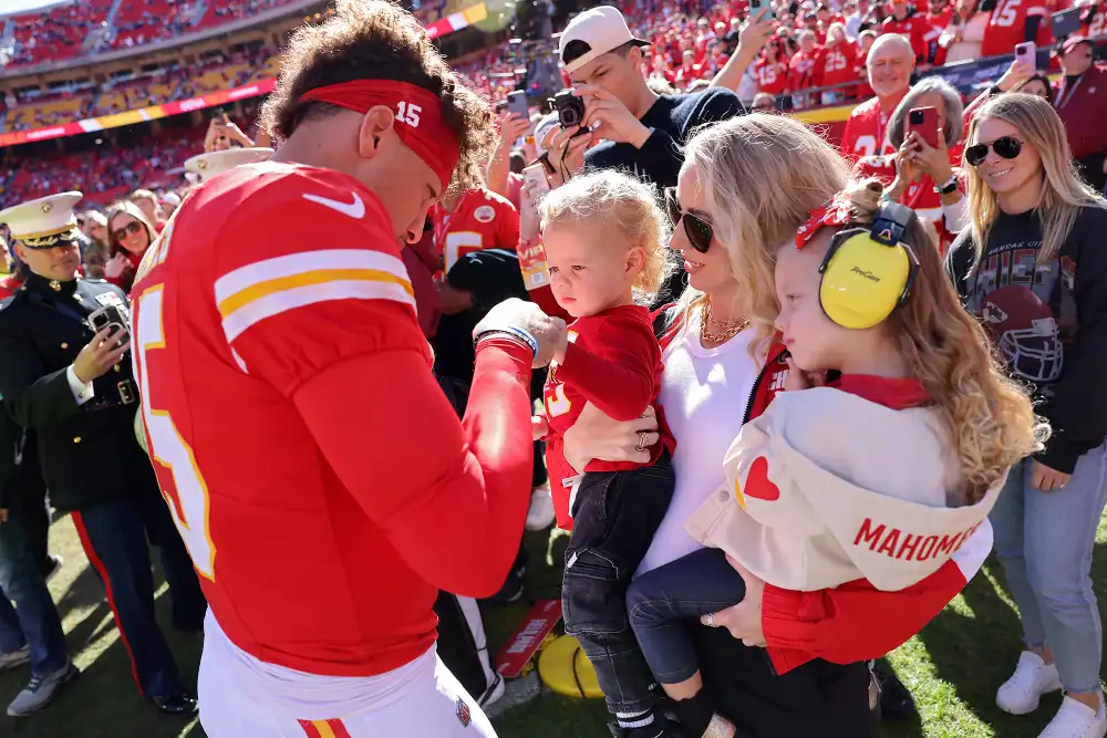 Brittany Mahomes Dresses Newborn Golden in Football Onesie 3