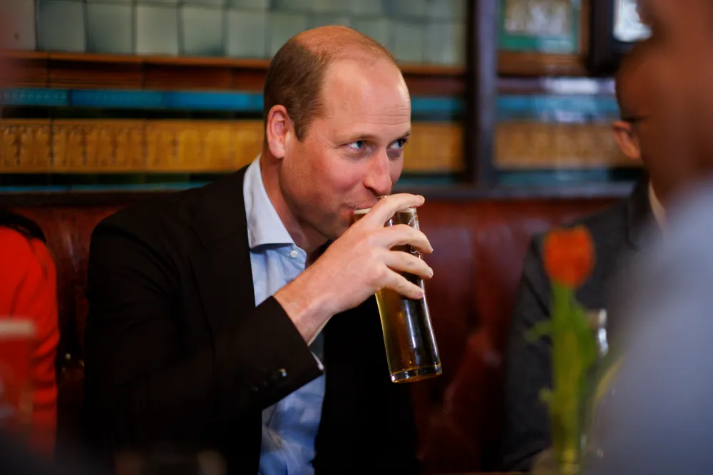 Prince William sips a pint of cider.