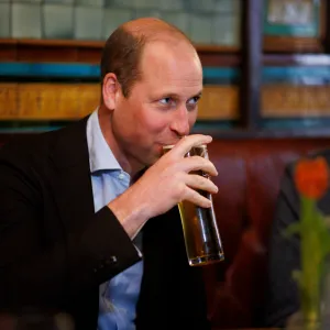 Prince William sips a pint of cider.