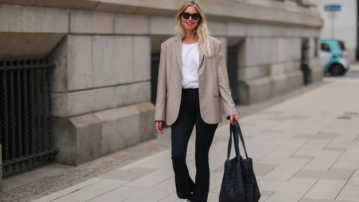 woman in beige blazer and black leggings
